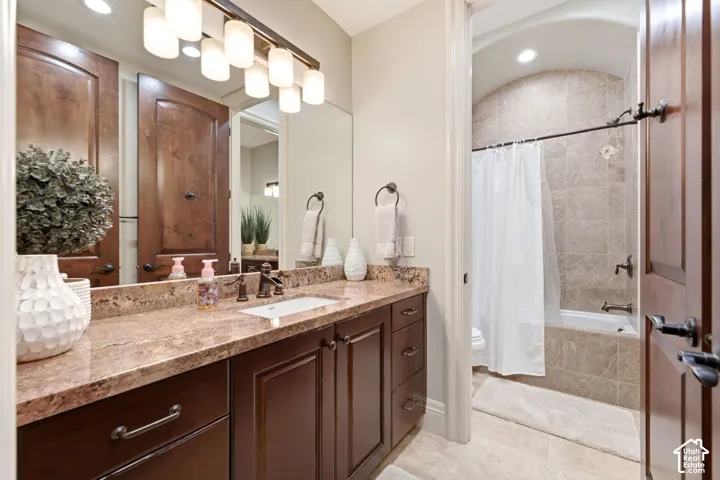 Vanity with a granite countertop and an undermount sink