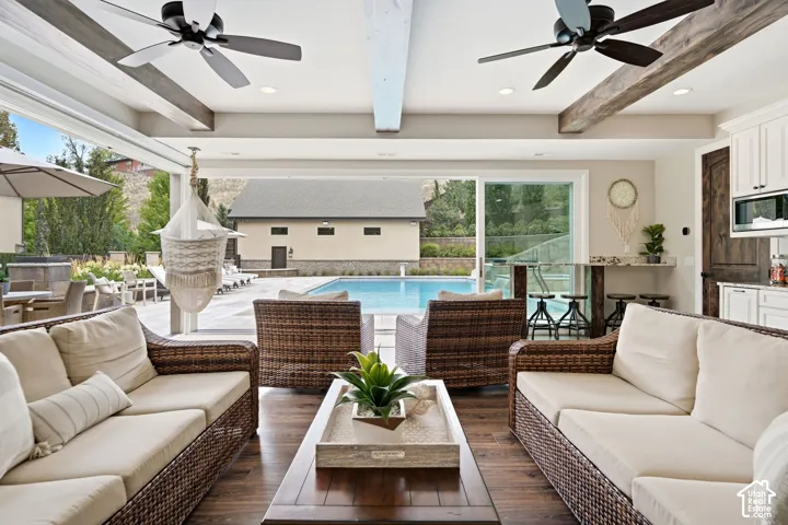 Casita with  Kitchen Laundrt amd floor to ceiling glass sliders. Spacious indoor-outdoor living area featuring wood-finish flooring and exposed ceiling beams