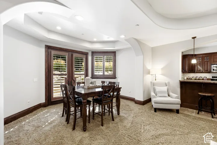 Recessed lighting, arched entryways, wood-finish window frames, and coved ceiling details