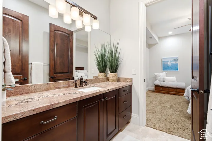Extended vanity with a rectangular undermount sink, bronze-finish faucet, and granite countertop