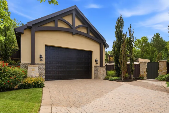 Detached Garage-Stucco and stone exterior with decorative wood-beam detailing