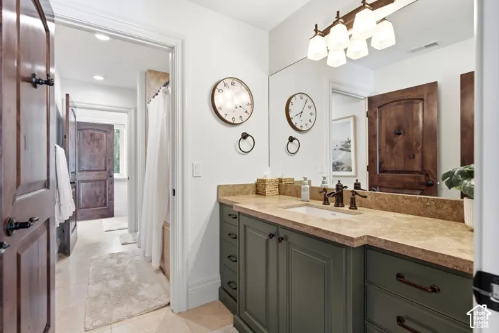 Integrated vanity with a single basin, stone countertop, and dark-finish faucet