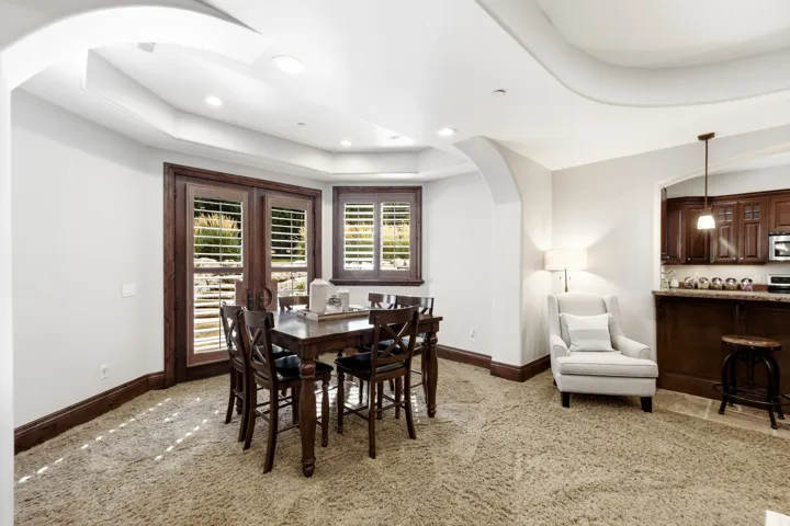 Recessed lighting, arched entryways, wood-finish window frames, and coved ceiling details