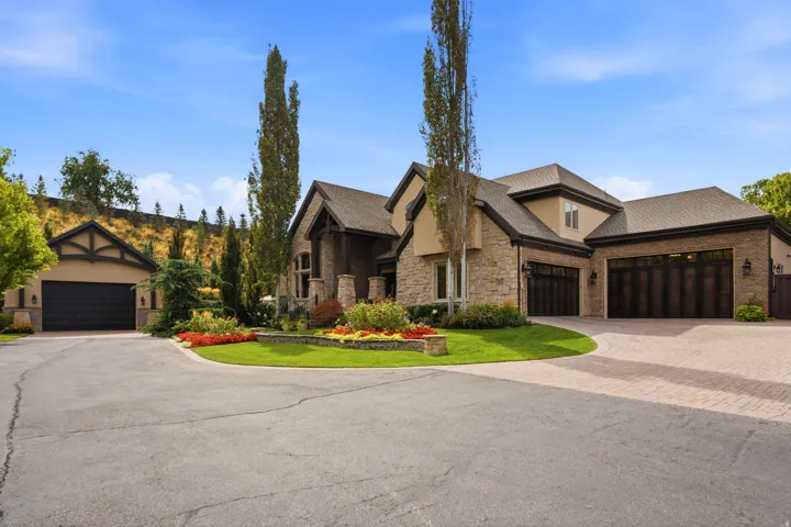 Striking stone and stucco exterior with multiple peaked rooflines and architectural detail