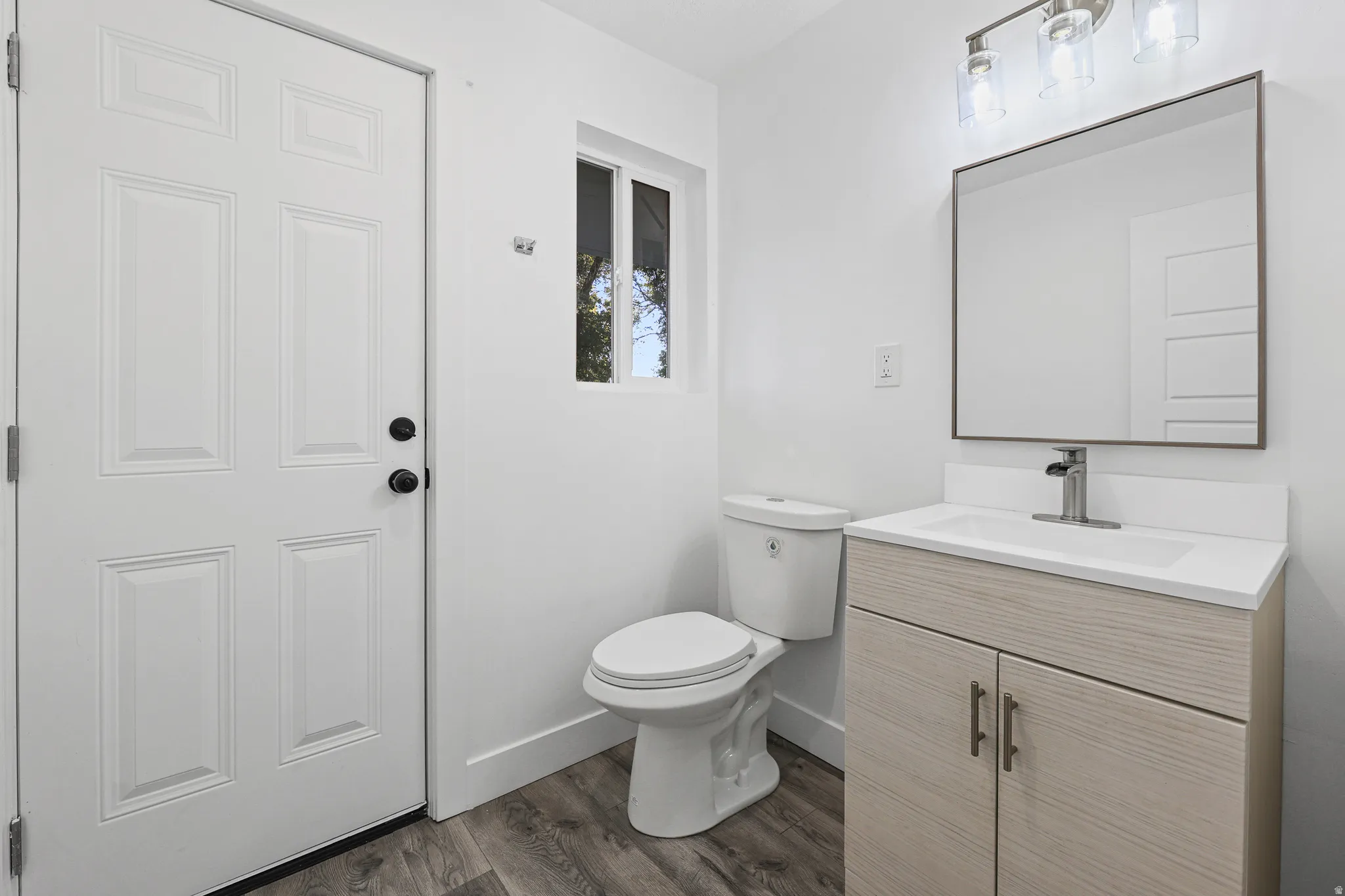1/2 Bath on Main Floor with Door to the Backyard