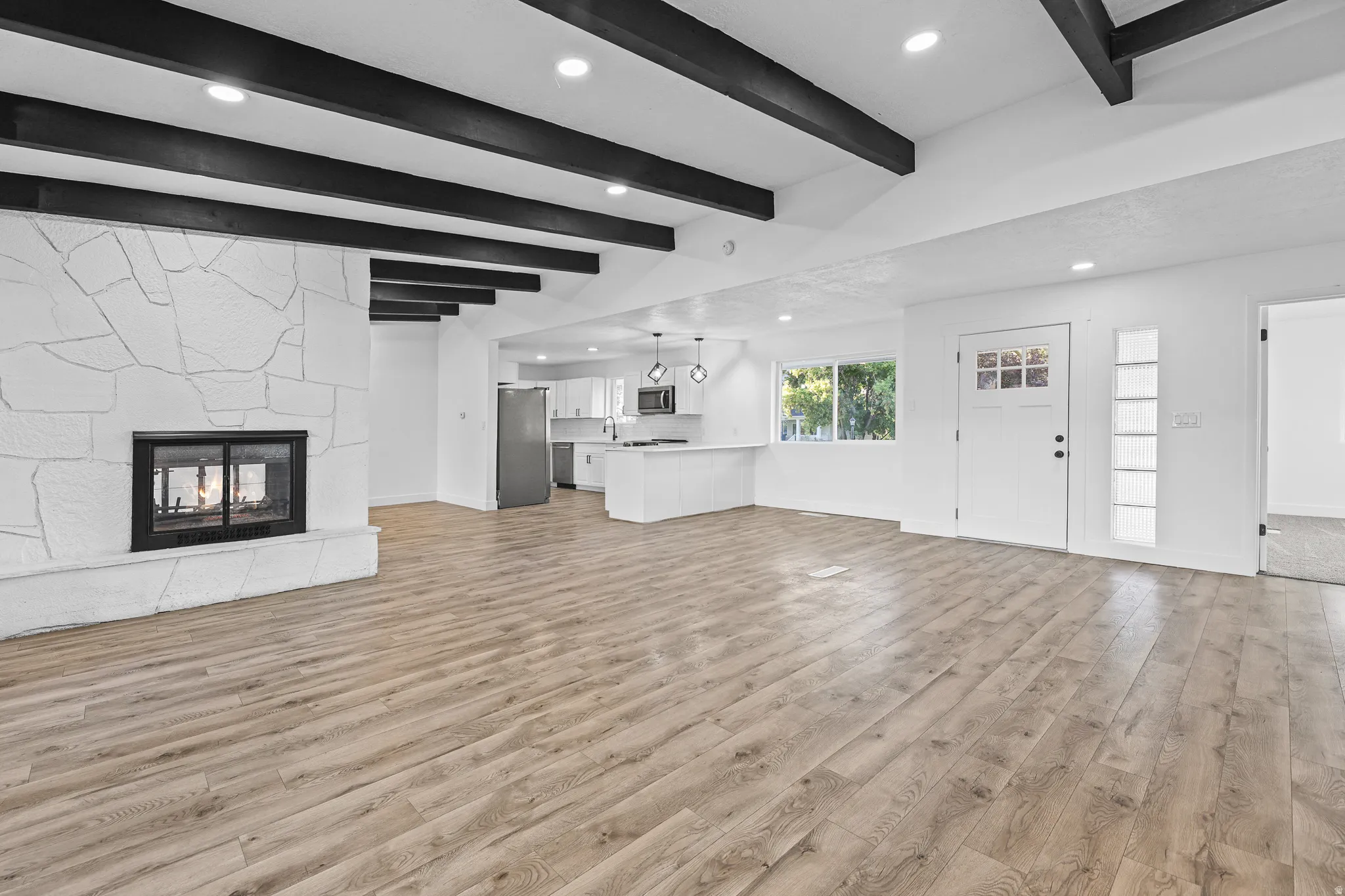 Open Concept Floorplan with Double Faced Fireplace and Beams