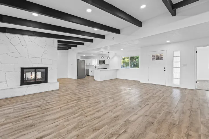 Open Concept Floorplan with Double Faced Fireplace and Beams