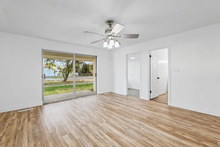 Primary Bedroom with Sliding Glass Door to Backyard with Doors to Sitting Area & Primary Bathroom