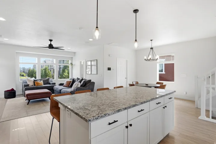 Kitchen island with a light-toned countertop and white cabinetry