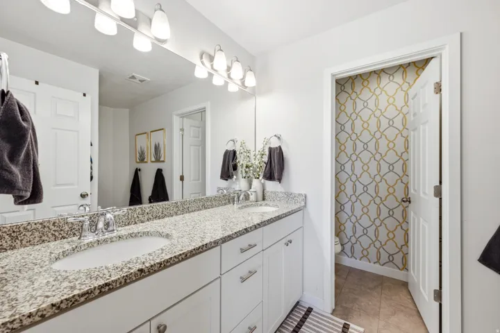 Dual vanity with granite-style countertop and integrated sinks