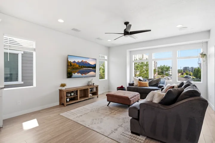 Recessed lighting, wood-finish flooring, ceiling fan, and large windows