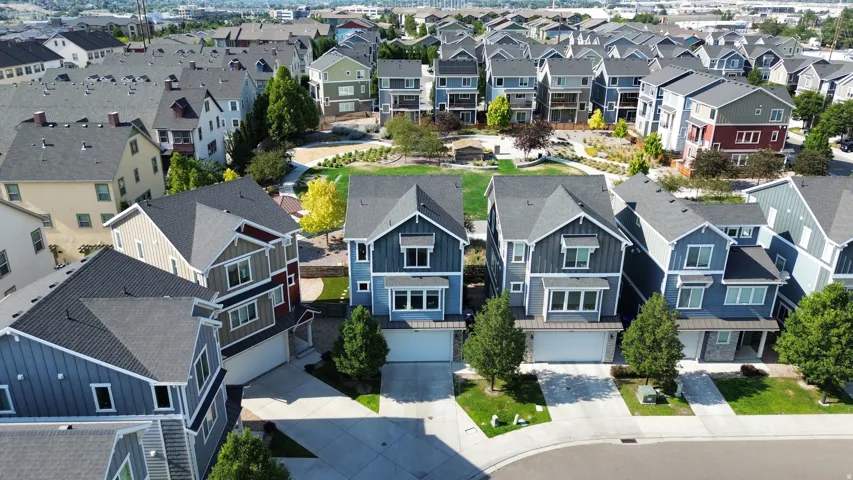Residential neighborhood featuring a community park, paved roadways, and mature landscaping