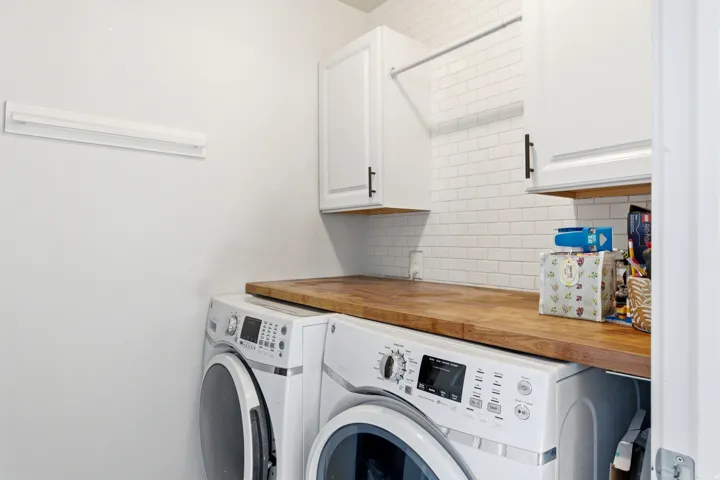 White subway tile backsplash with wood-finish countertop
