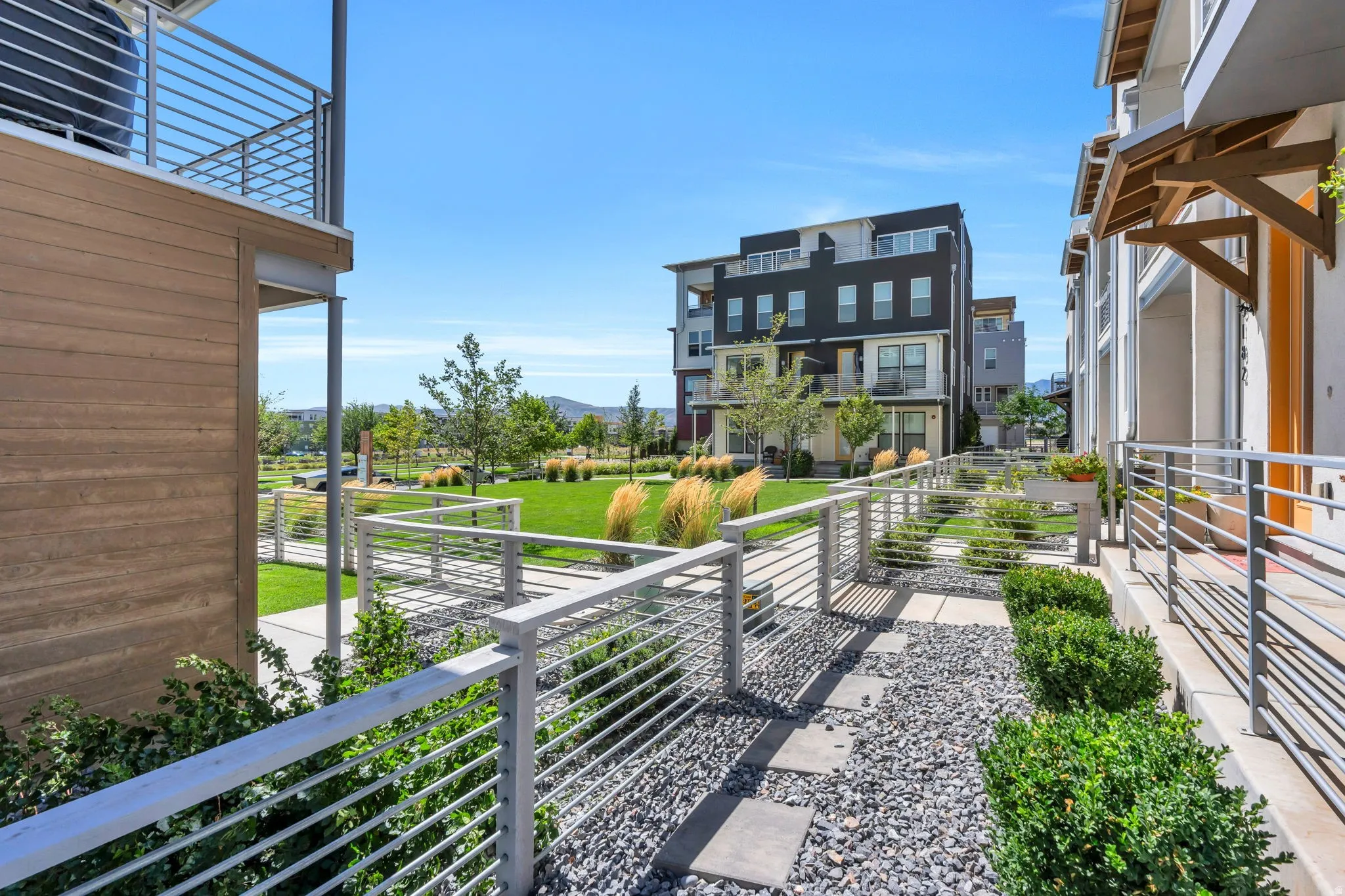 Modern architecture featuring exterior wood-finish siding and multiple balconies