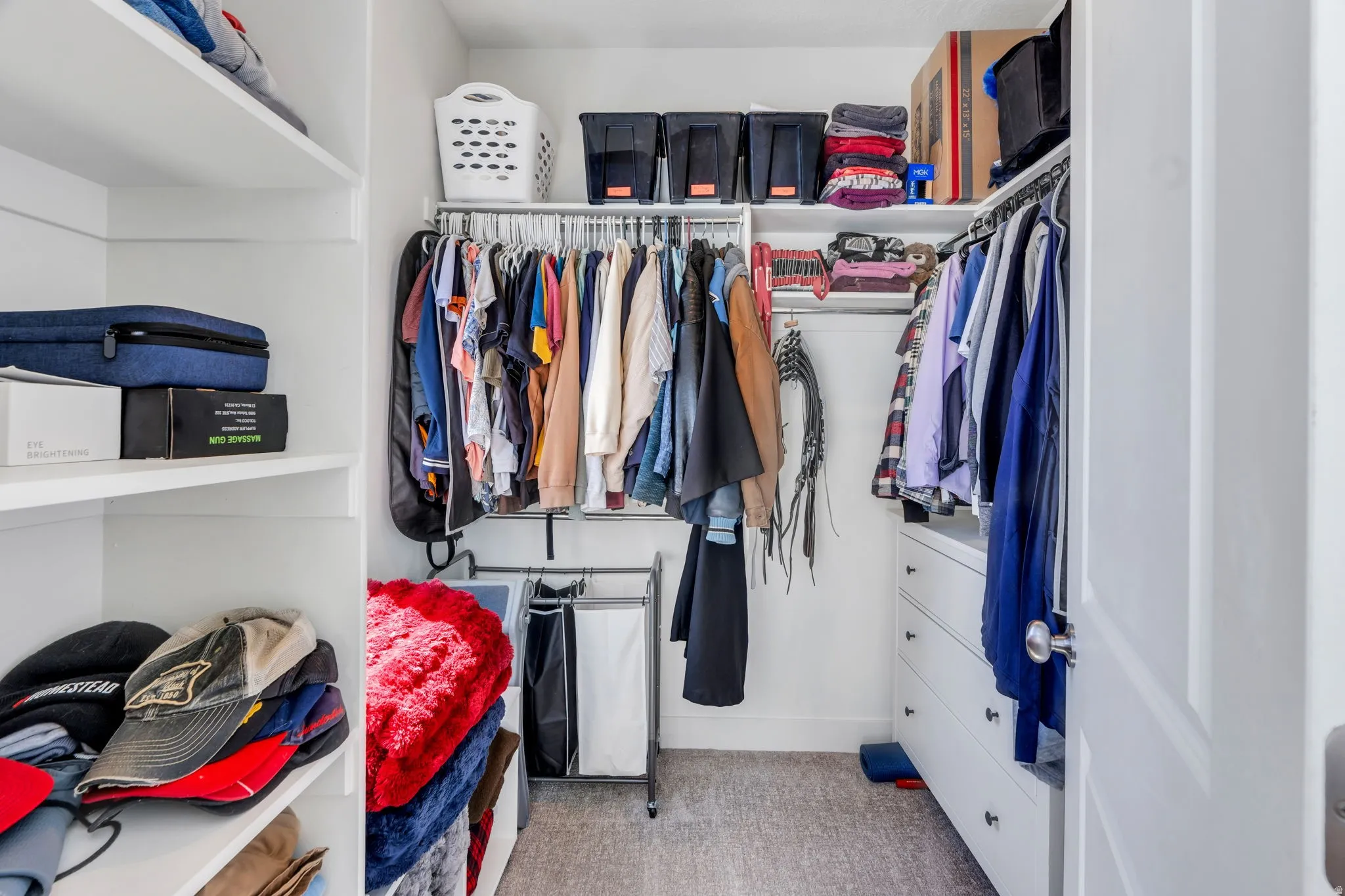 Walk-in closet featuring built-in shelving, hanging rods, and integrated drawers
