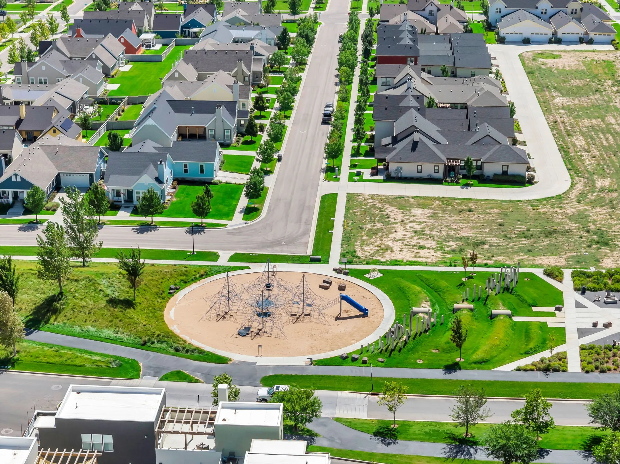 Community park with playground, recreational green spaces, and paved walking paths