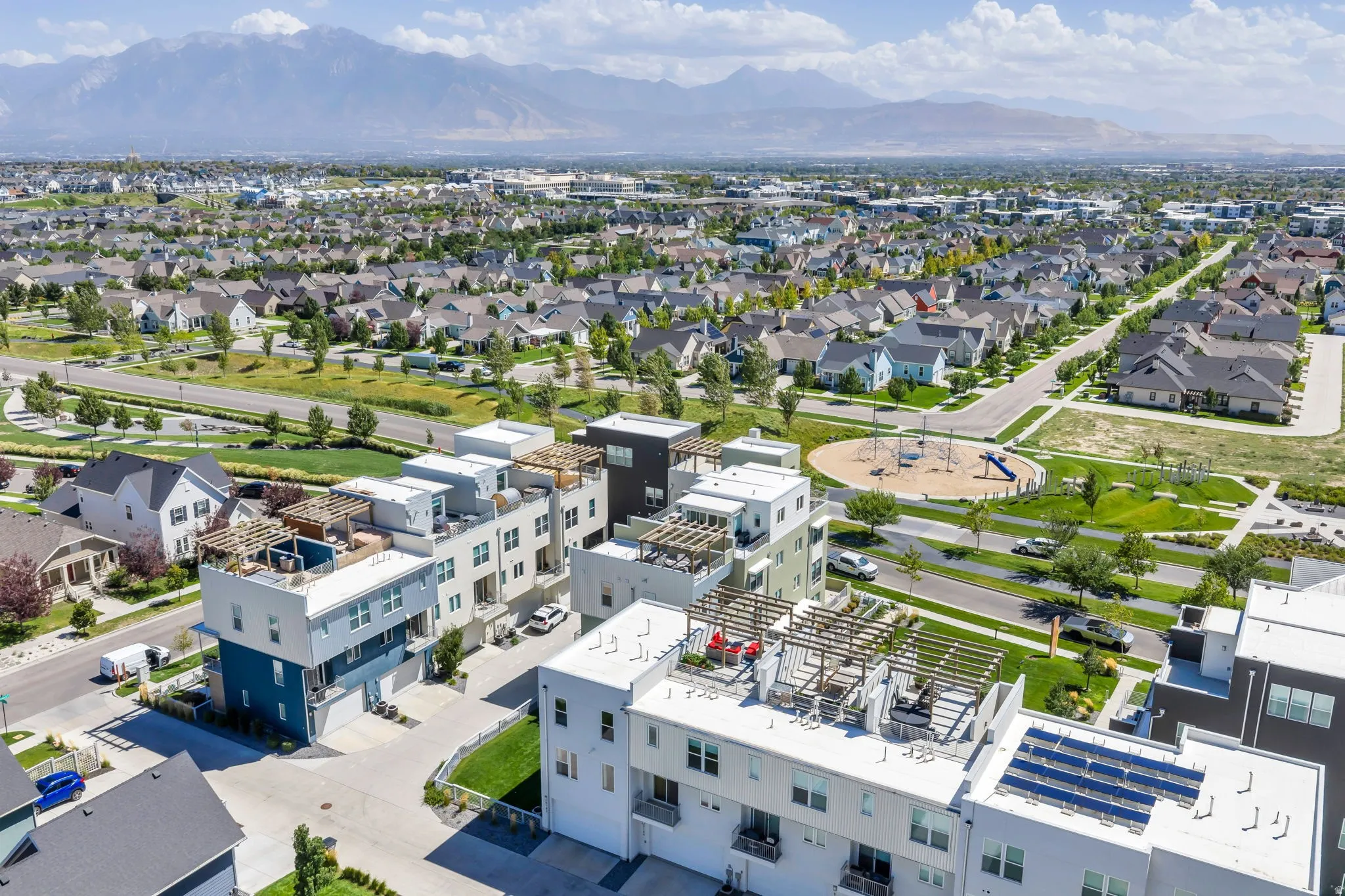Rooftop terrace with pergola, contemporary multi-story design, attached garage, solar panel installation, and direct park access