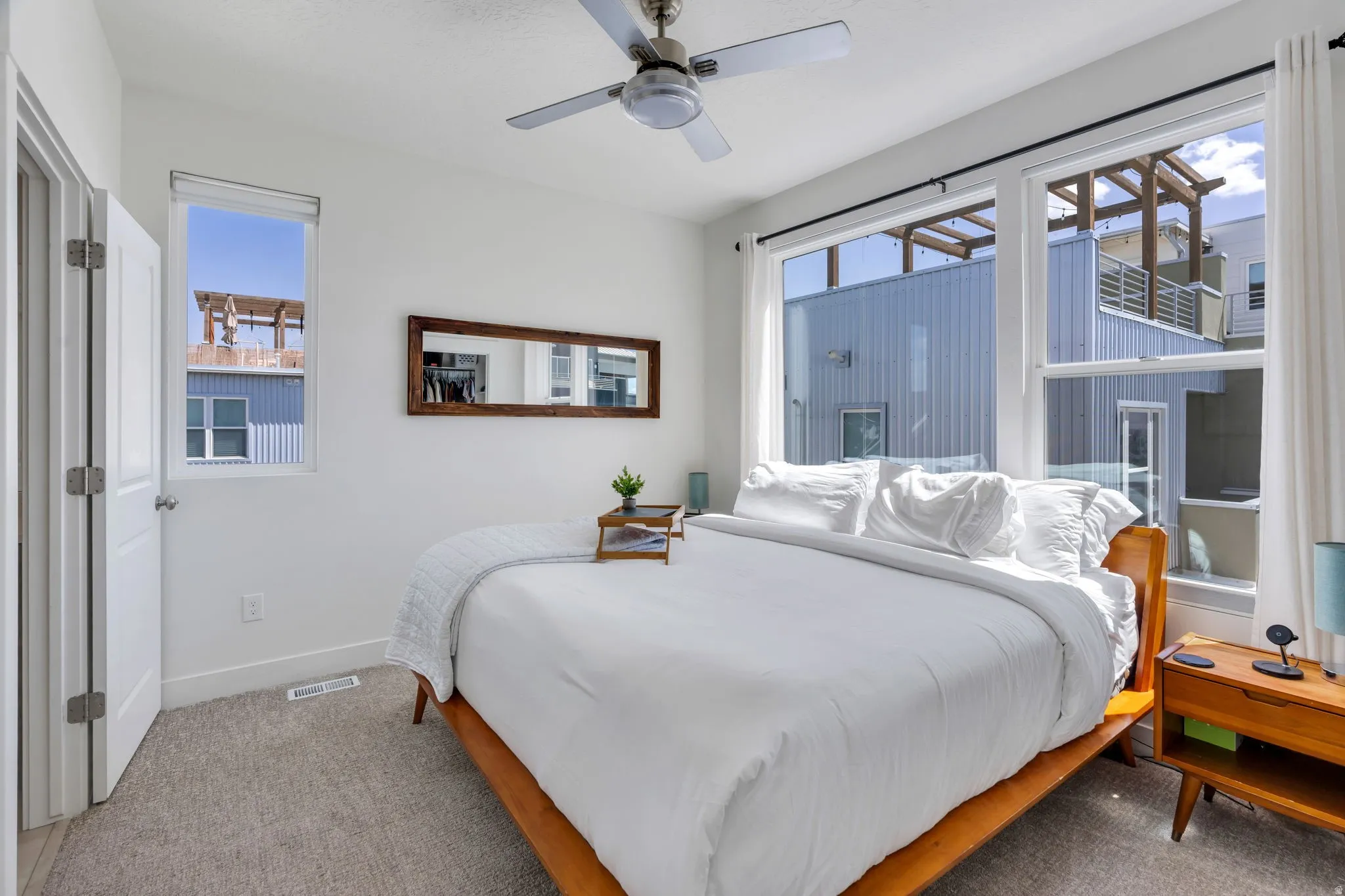 Recessed lighting, large windows, and a ceiling fan with integrated lighting