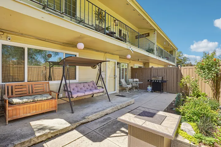 Private patio with concrete surfacing, wood fencing, and established perimeter landscaping