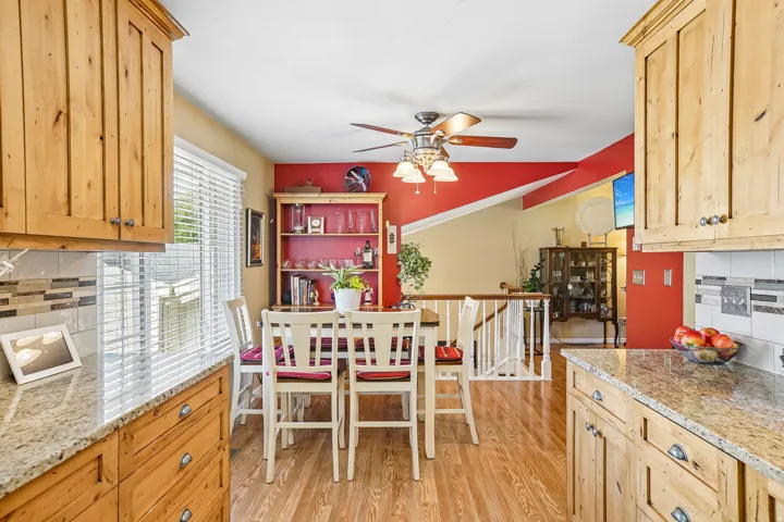 Wood-finish flooring with natural wood cabinetry and light-toned countertops