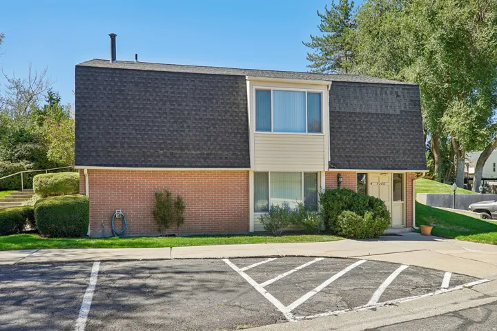 Brick and siding exterior with an asphalt shingle roof