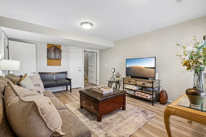 Recessed ceiling lighting, light wood-finish flooring, and neutral wall paint