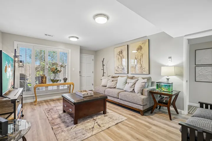 Light wood-finish flooring complements the neutral wall tones