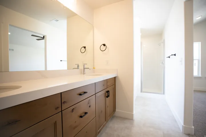 Primary bathroom featuring dual vanity and separate tub and shower