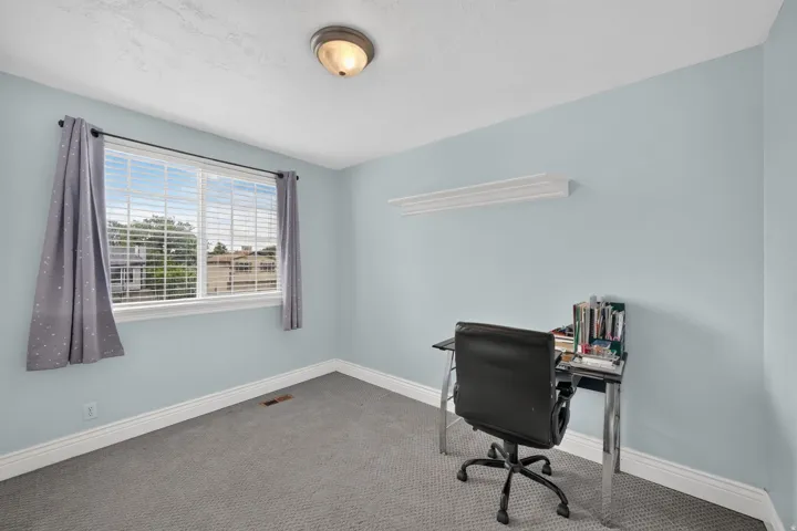 Light blue painted walls with white trim and a single window