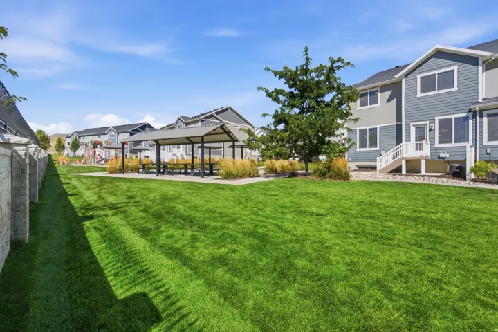 Expansive green lawn with a stone-clad perimeter wall
