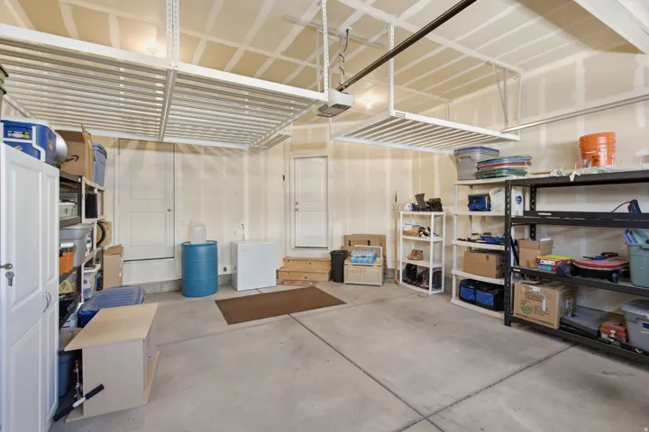 Concrete flooring with overhead storage racks and dual entry doors