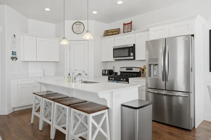 Well-appointed kitchen featuring white cabinetry, stainless steel appliances