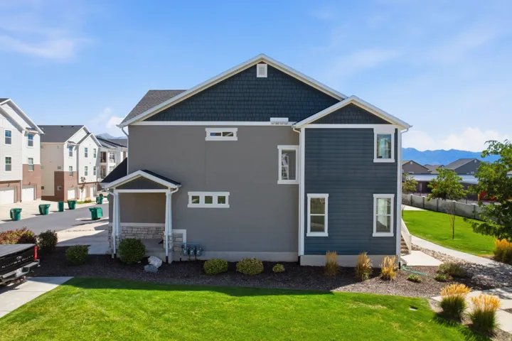 Side of townhome. Multi-level siding exterior featuring horizontal and shake panels