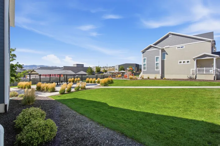 Manicured lawn and open green space to the side the unit.