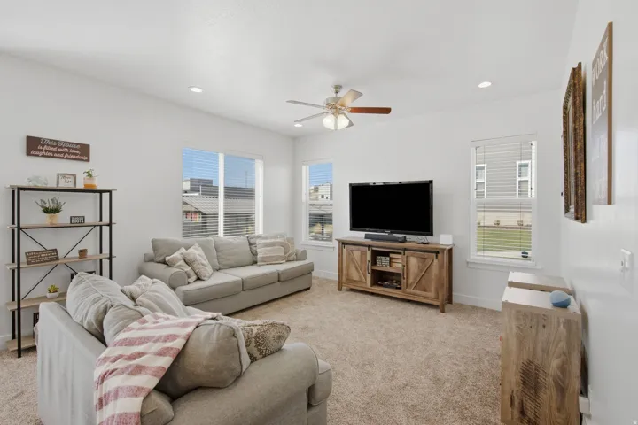 Recessed lighting, ceiling fan, multiple windows, carpet flooring, and white walls