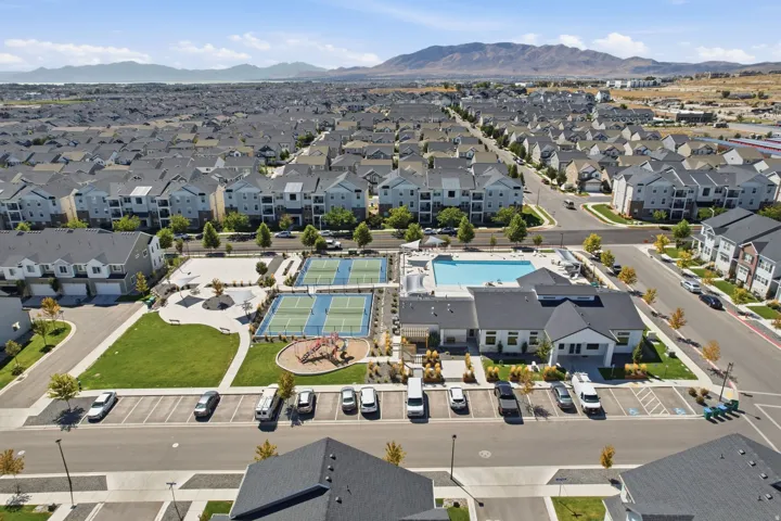 Community amenities featuring a swimming pool, tennis courts, and recreational green space