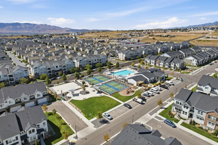 Community amenities featuring a swimming pool, two tennis courts, a playground, and a central green space