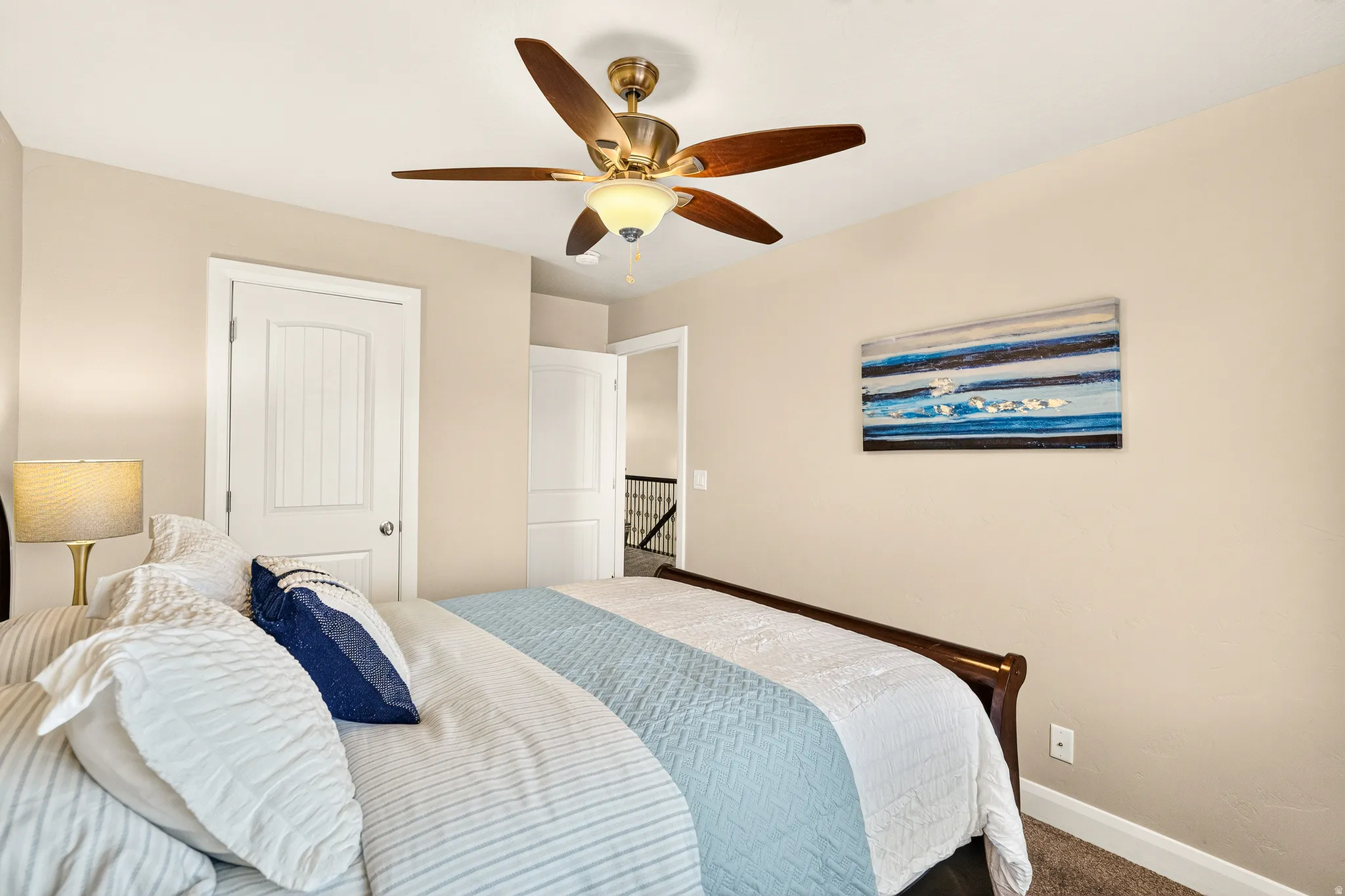 Recessed panel interior door, ceiling fan with integrated lighting, and neutral wall tones