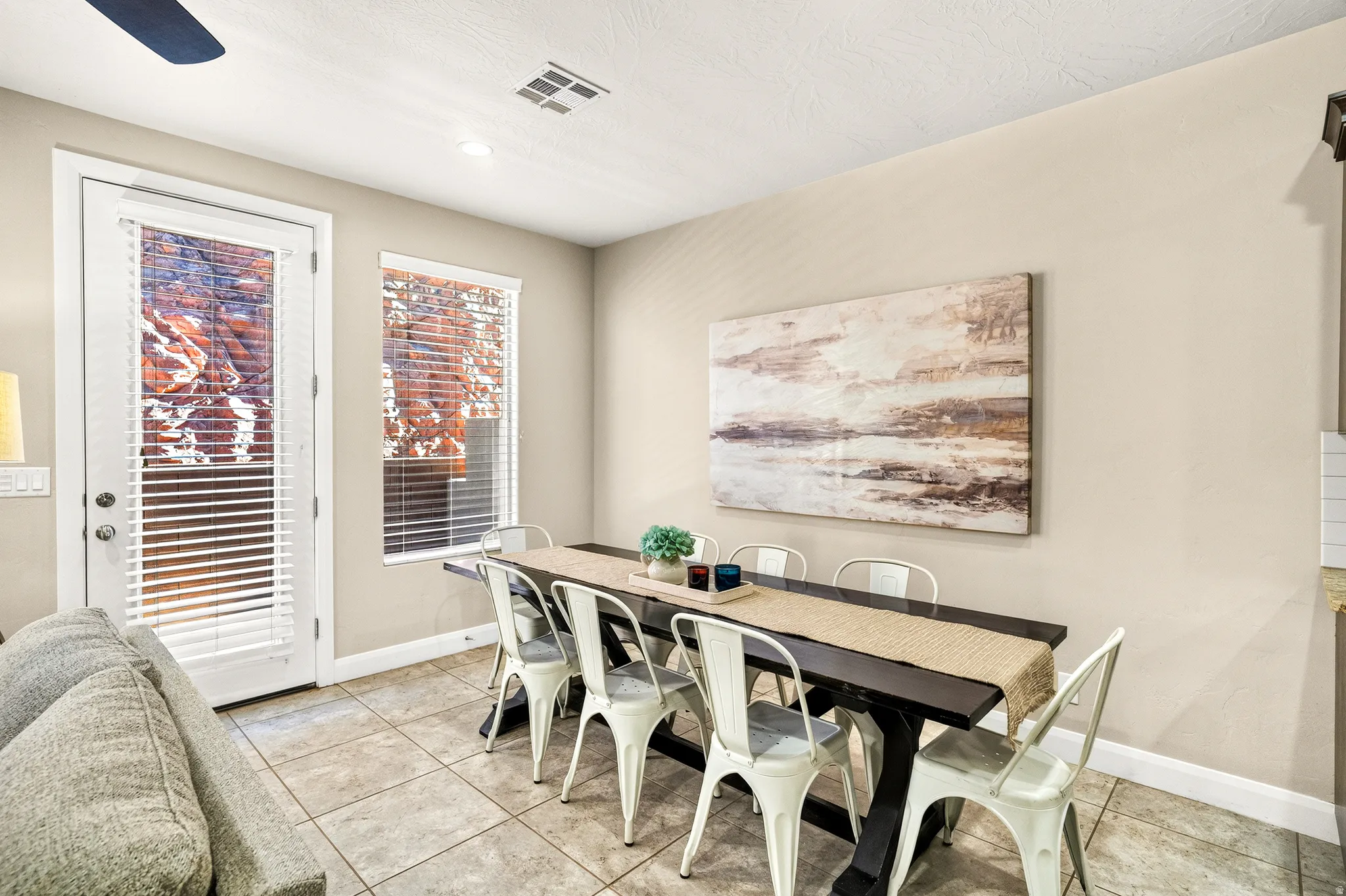 Recessed lighting, ceiling fan, tile flooring, and a glass-paneled exterior door