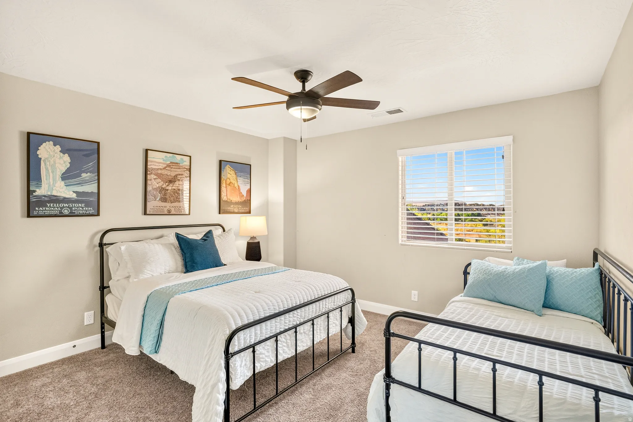 Ceiling fan with integrated lighting, window with horizontal blinds, neutral wall paint, and textured carpeting