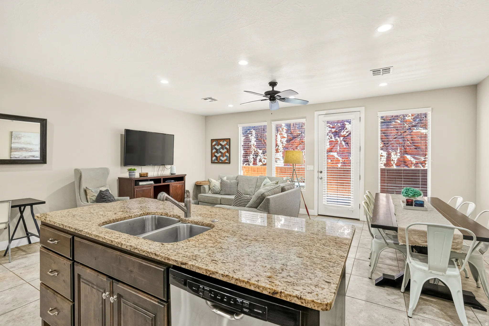 Kitchen island featuring an undermount double-basin sink and stainless steel dishwasher