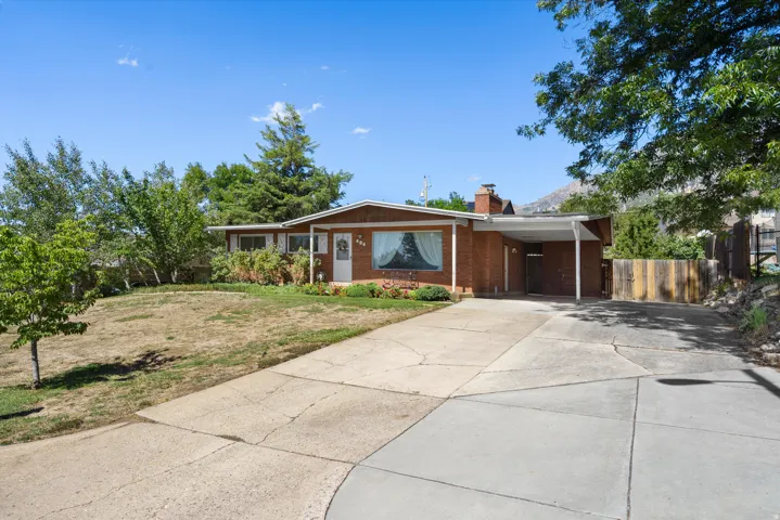 Brick exterior with an attached carport and a prominent front door