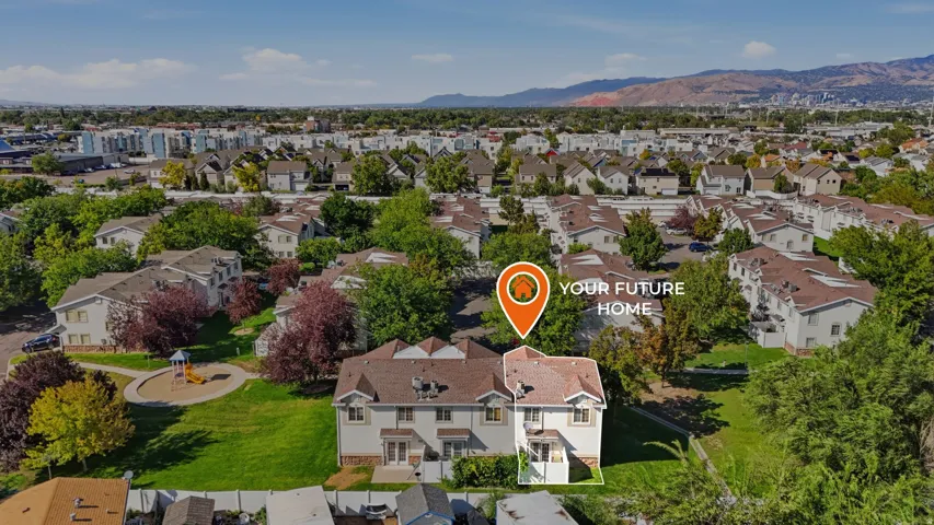 Aerial perspective showcasing the property within a residential community with distant mountain ranges