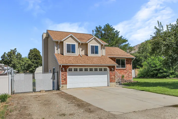 Two-story home featuring brick and siding exterior, an attached two-car garage, and a concrete driveway