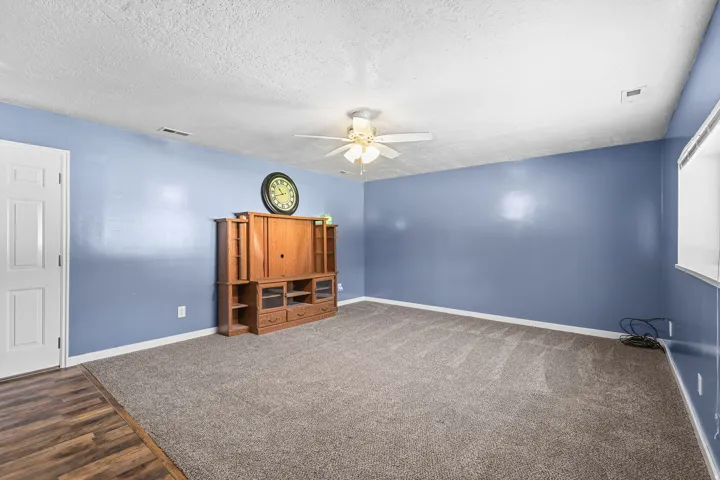 Recessed window, ceiling fan with light fixture, wood-finish flooring, and wall-to-wall carpeting
