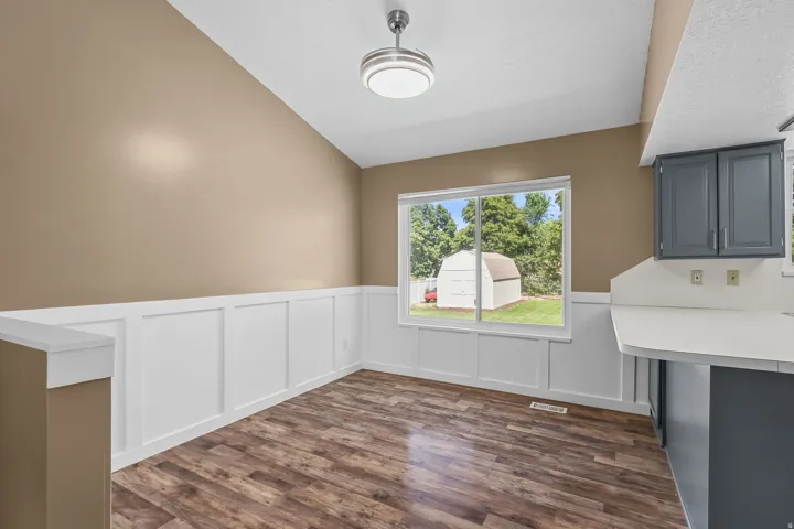 Wood-finish flooring with white wainscoting