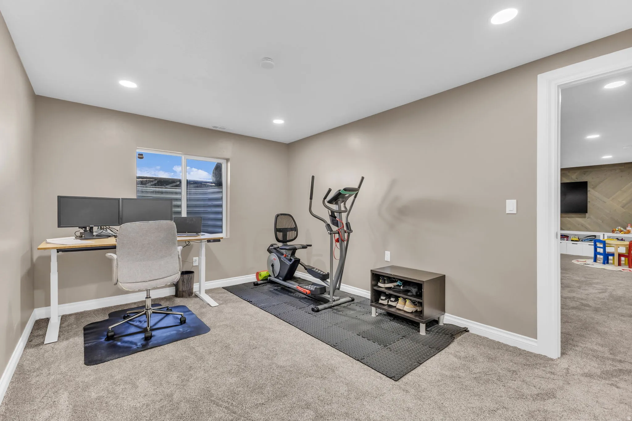 Carpeted room with a window, recessed lighting, and neutral wall tones