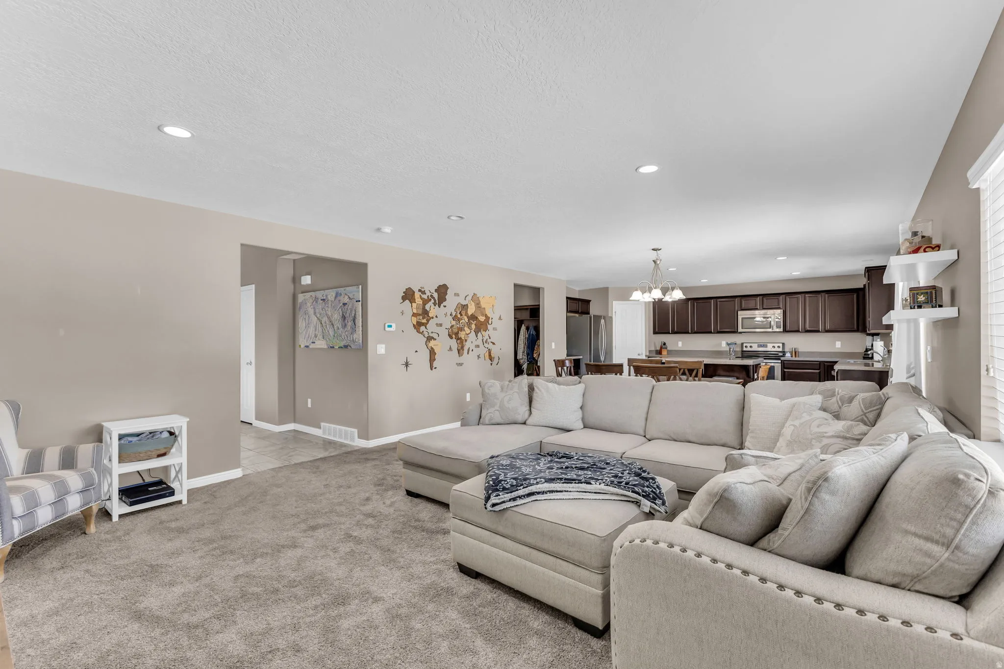 Recessed lighting, neutral wall tones, and carpeted flooring