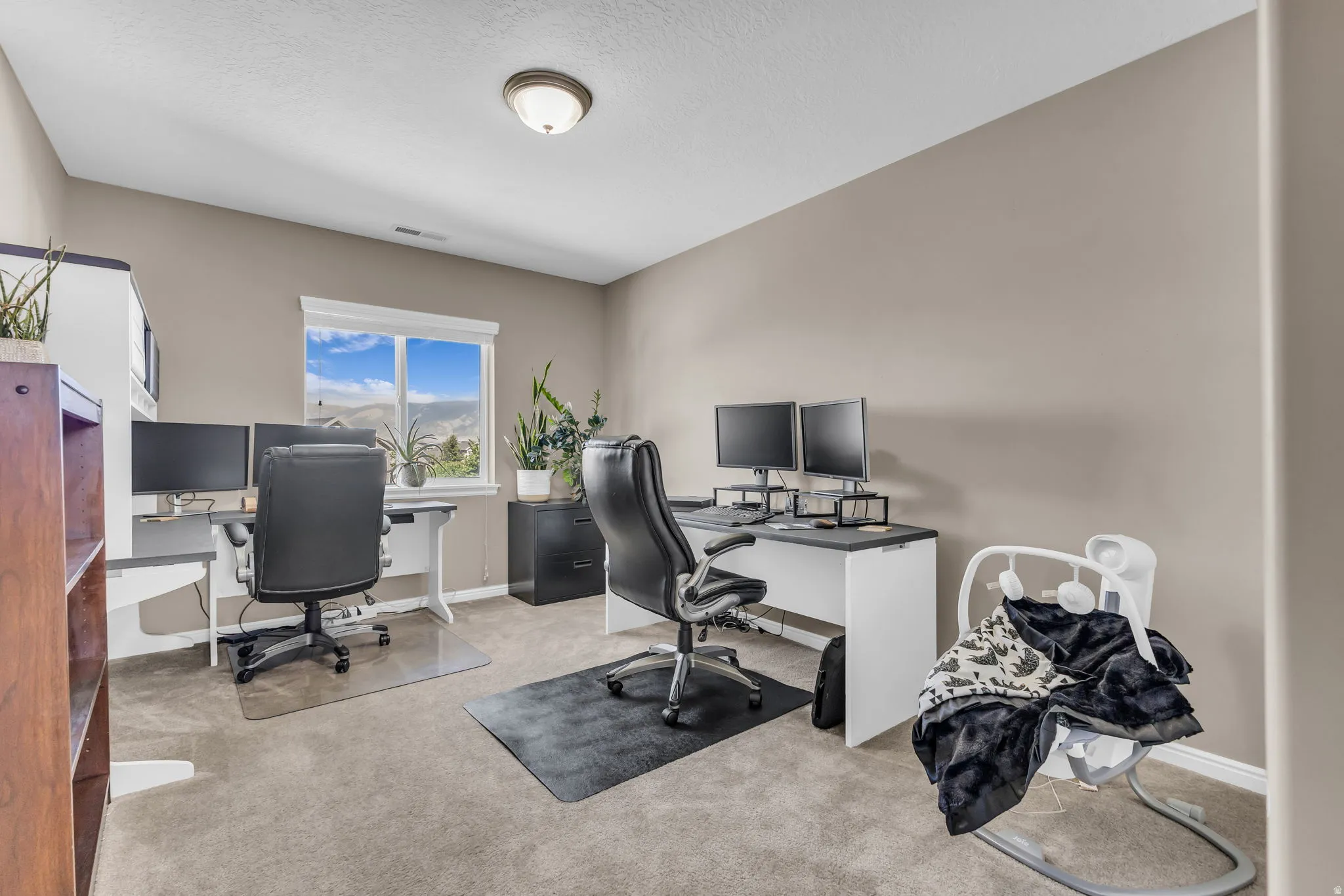 Room featuring neutral wall tones, recessed lighting, a window with exterior scenery, and carpet flooring