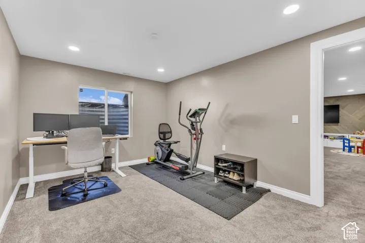 Carpeted room with a window, recessed lighting, and neutral wall tones